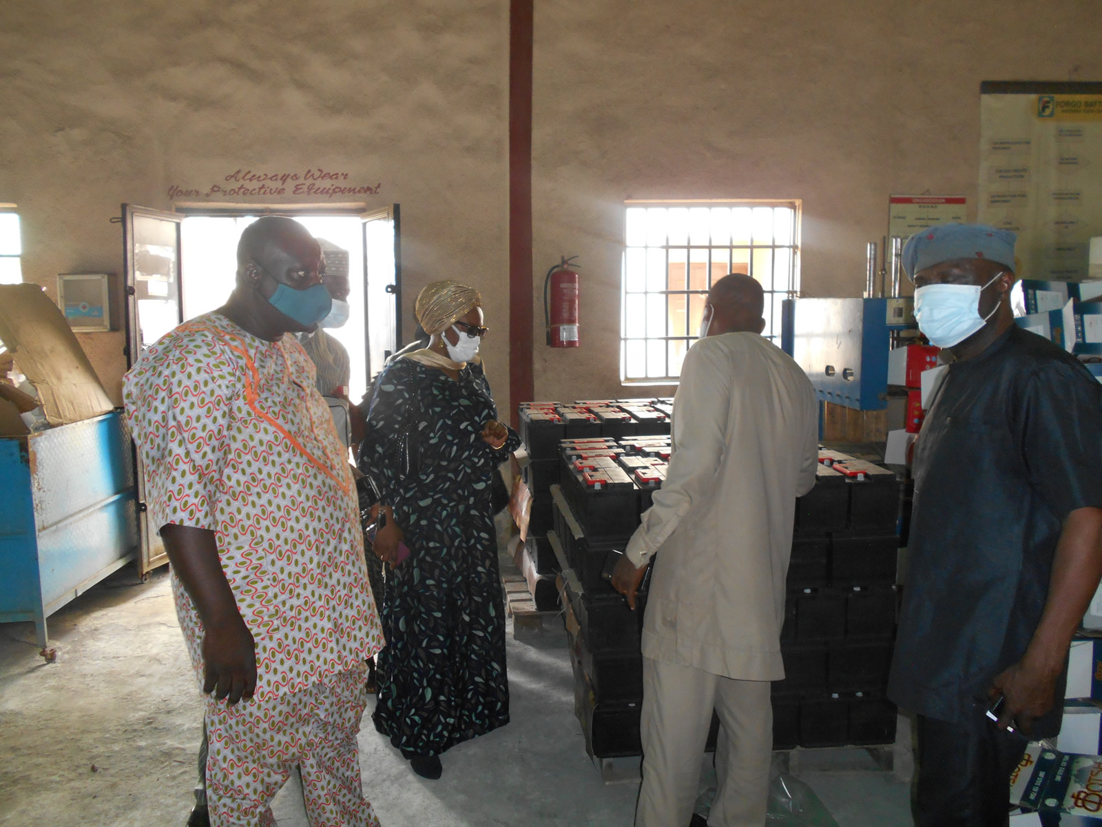 The MD taking the Commissioner of Enterprise and her entourage on a tour of the factory